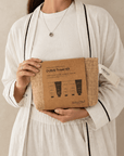 Dubai Travel Kit with five essential self-care products in a reusable woven pouch