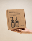 Signature Hand Ritual Set with exfoliating hand wash and resurrection hand balm in refillable glass bottles